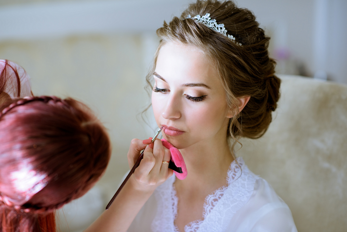 Wedding makeup artist making a make up for bride